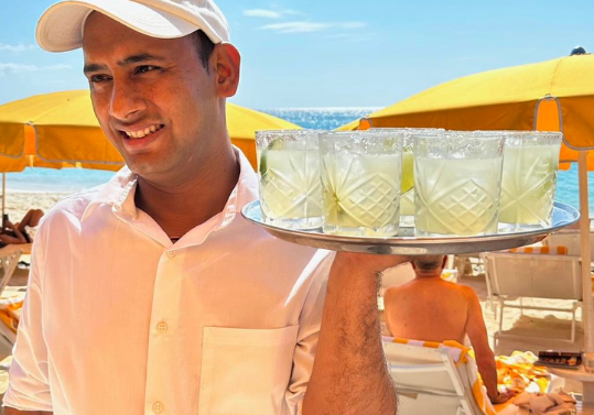 waiter carrying tray of drinks